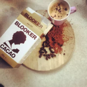 A pack of Blooker cacao and cup on wooden board